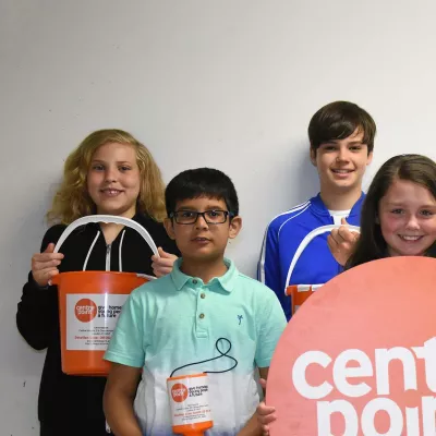 Group of children holding Centrepoint collection buckets