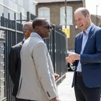 Prince William stands and talks to Centrepoint CEO Seyi Obakin OBE outside the Reuben House development