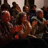 People listening to a panel discussion clap the speakers