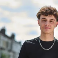 Young person standing outside and looking directly at camera