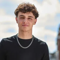 Young person standing outside looking to camera