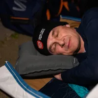 Sleep out participant in sleeping bag