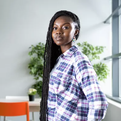 Young person inside next to window