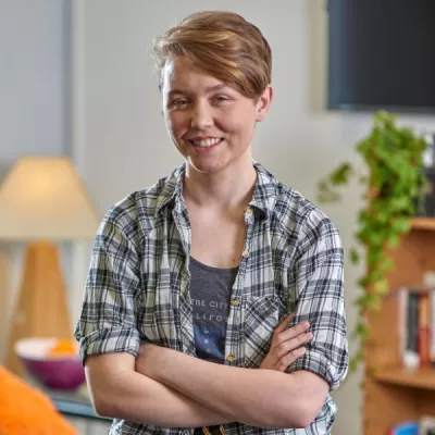 Young person with their arms crossed 