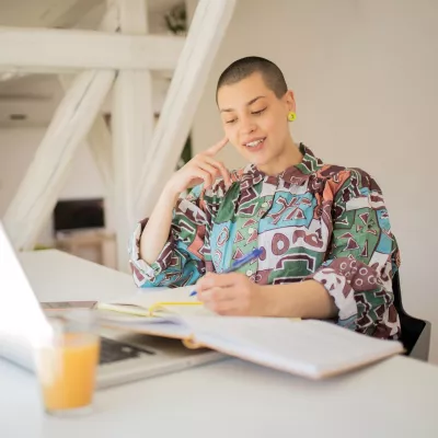 A young person works at a laptop.