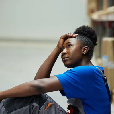 Woman looks worried in warehouse