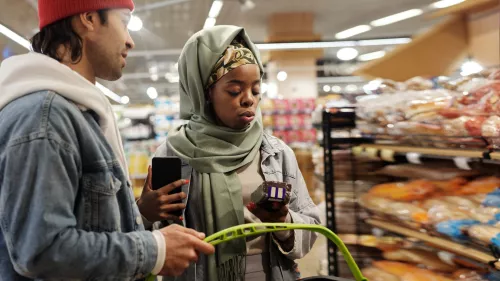 Two young people in a supermarket shopping