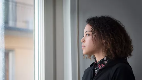 Young person looking out the window.