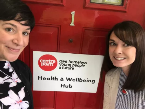 Photograph of Centrepoint health team workers Monica and Hayley in front of the door of the Health and Wellbeing Hub