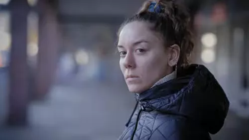 Young person in hooded jacket outside