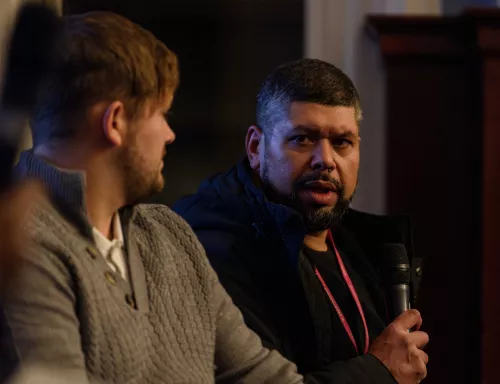 Two men talking with a microphone