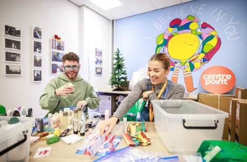 Dean McCullough and a Centrepoint staff member put together winter support kits for homeless young people.