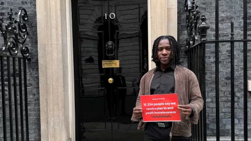 Young person holding placard outside Downing St