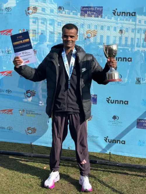 Young man smiling holding a trophy