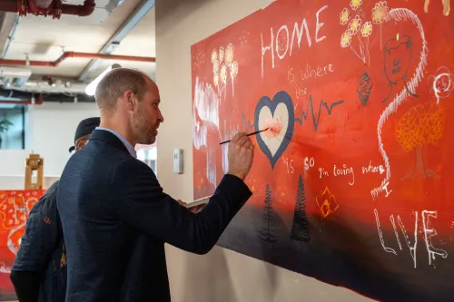 HRH Prince William contributes to the painted mural at the Centrepoint head office