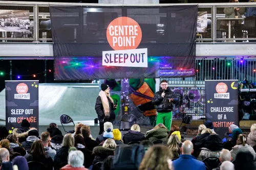 Dean McCullough speaks to the crowd from the Sleep Out stage