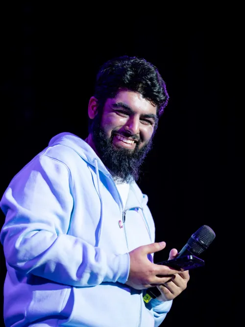 A young person smiles on stage