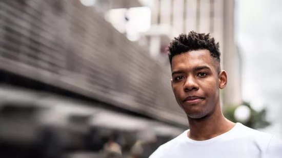 Young person standing outside in white T-shirt