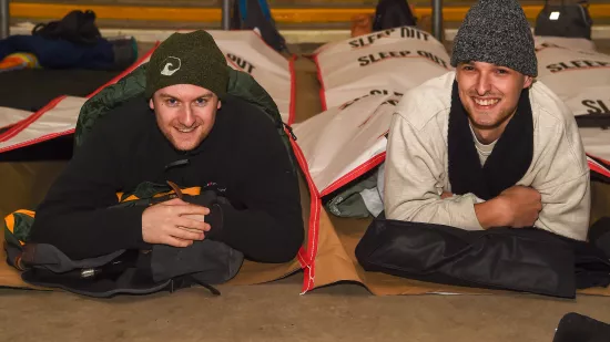 Two people on Sleep Out lying on the floor