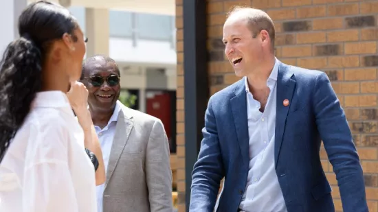 Prince William is laughing in conversation with Centrepoint residents and staff.