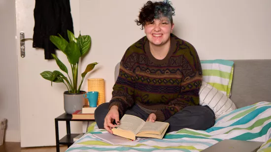 Tal reading on their bed at a Centrepoint service