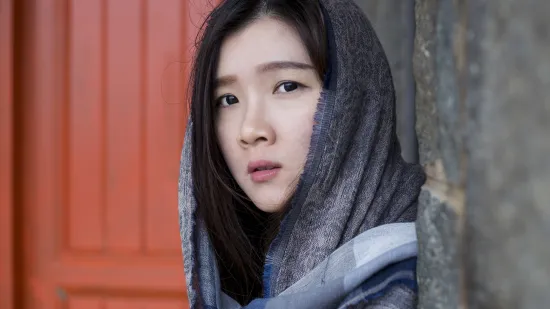 Young women coming round the corner of an alley entrance, looking directly at viewer.