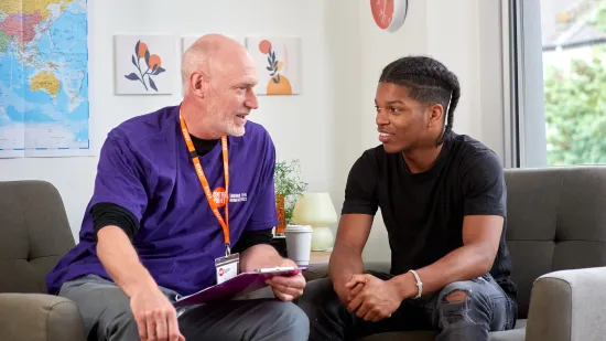 Centrepoint young person and staff member in discussion on sofa