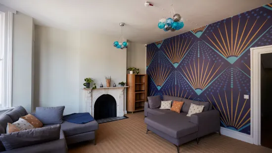 Centrepoint accommodation recently refurbished with new sofas, lighting and stylish wallpaper through Nationwide More Than a Roof