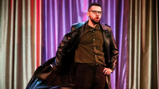 Young person stands on stage