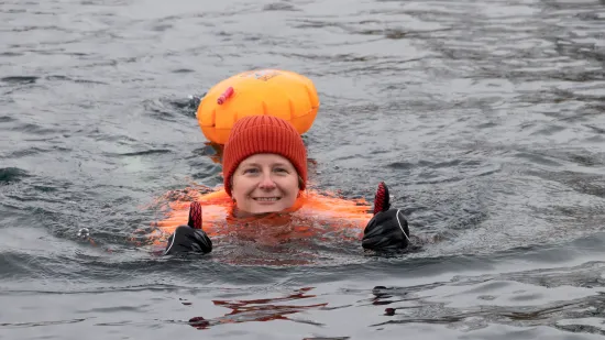 Participants swimming in water with thumbs up