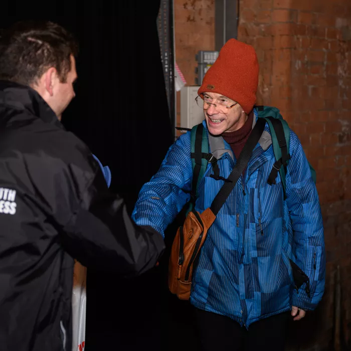 Staff member greets participant