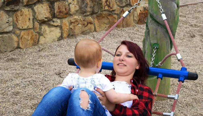 Person on hammock holding baby