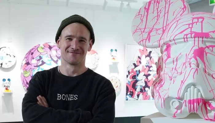 Ed standing in front of his artwork