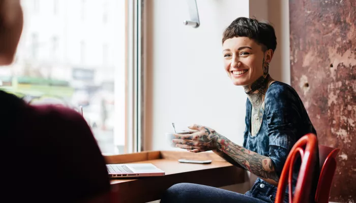 Young person sat at a desk by a window