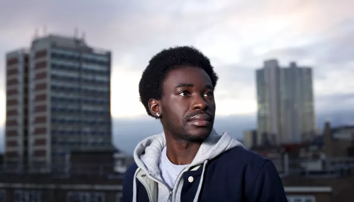 Young person with two high rise buildings in background