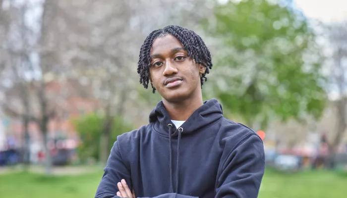 Young person with arms crossed
