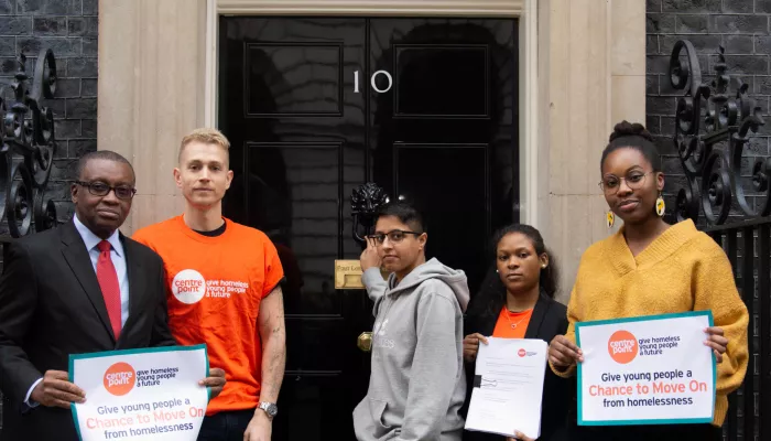 James McVey stands outside 10 Downing Street with Centrepoint residents as they hand in a petition to improve Universal Credit 