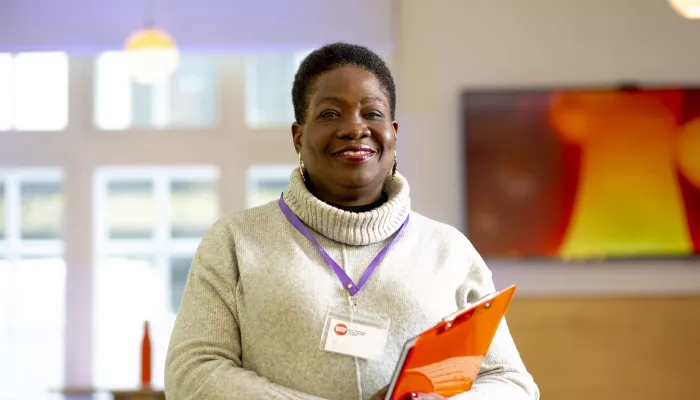 Person with lanyard and clipboard