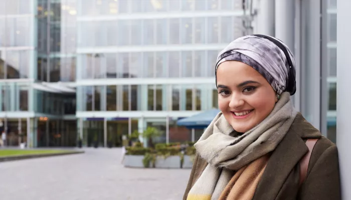 Young person in front of office buildings