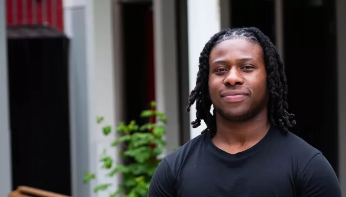 Young person in black t-shirt smiling