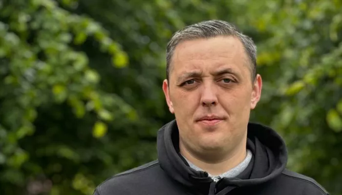 Close up of man facing the camera standing in a park