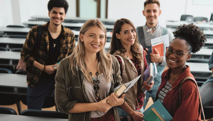 A group of young people stand in a learning environment.
