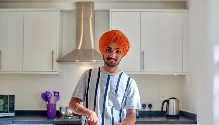 A young person prepares some healthy food in a homely kitchen