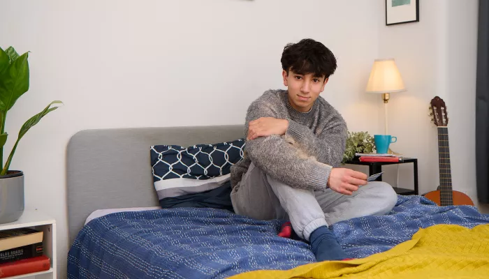 Carim on his bed in a Centrepoint service 