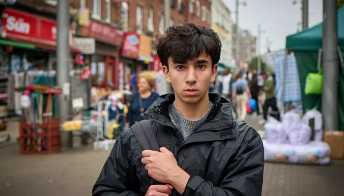 Carim stood in a bus street clutching his bad