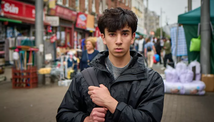Carim in a busy street clutching his bag