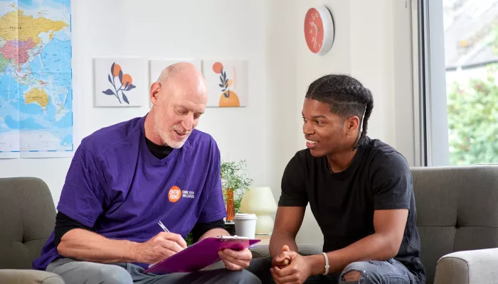 A counsellor sits and talks with a young person in a Centrepoint service 