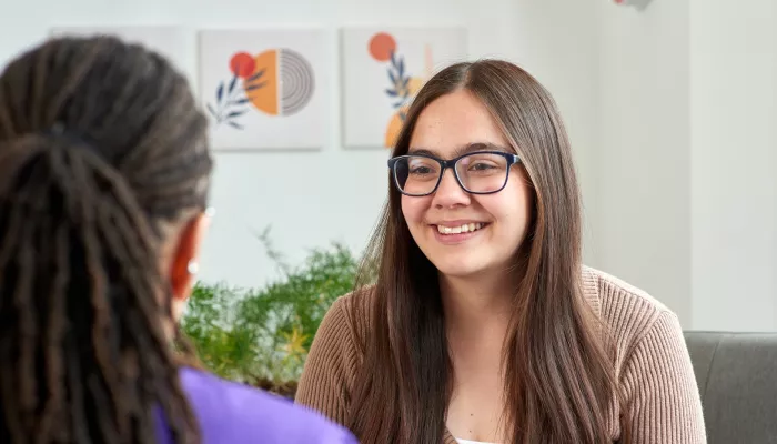 A young person smiles in a session with a Centrepoint counsellor