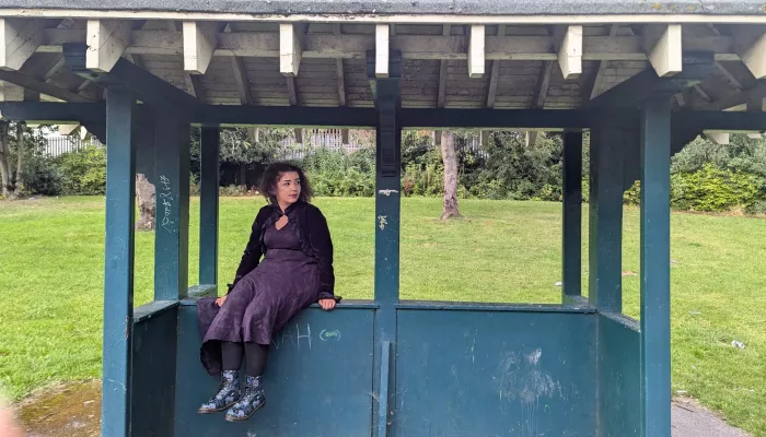 Young person sitting at bus stop