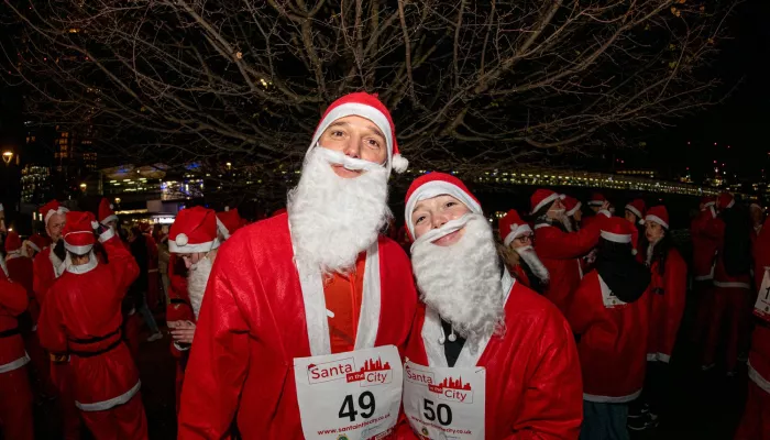 Two people dressed as Santa